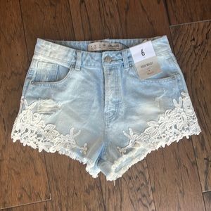 NWT Denim Co High Waisted Distressed jean shorts. Lacy detail. Button Fly.